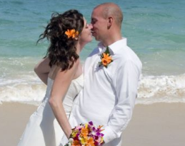 Bride and groom at beach celebrating wedding