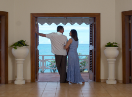 Couple overseeing the beach from their room.
