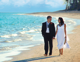 Couple walking on beach after wedding
