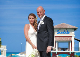 Bride and groom posing for wedding picture at beach