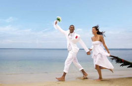 Bride and groom at beach at the Hotel Riu Naiboa